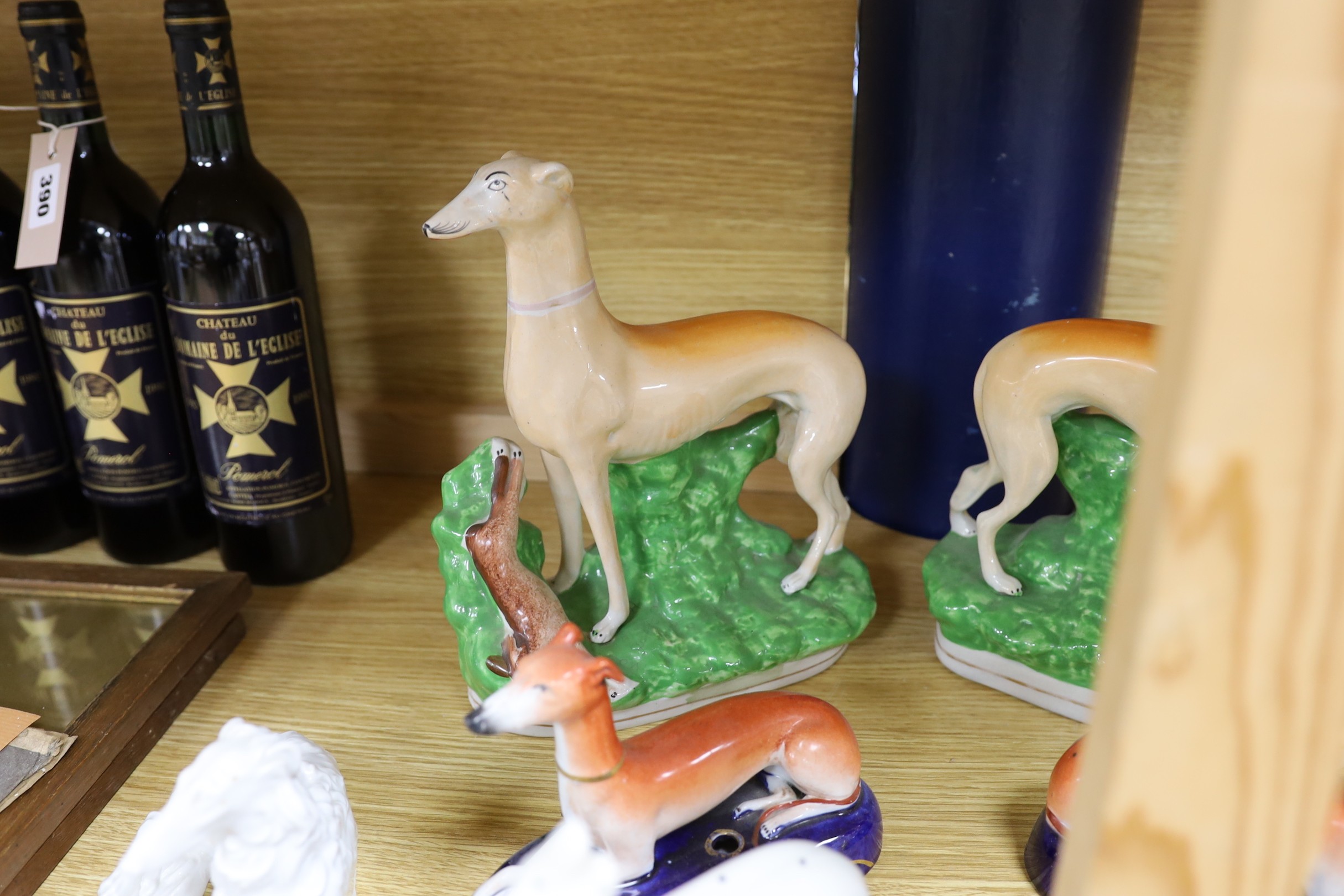 A collection of four pairs of Staffordshire dogs, together with nine other models of reclining hounds, tallest 25cm